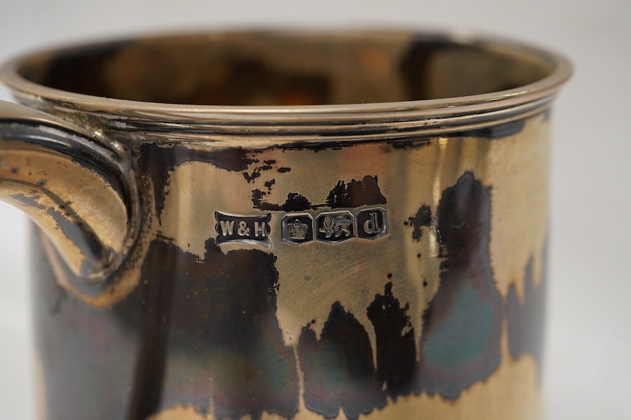 A George V silver mug by Walker & Hall, Sheffield, 1921, on a circular foot, height 12.5cm, 9.5oz.